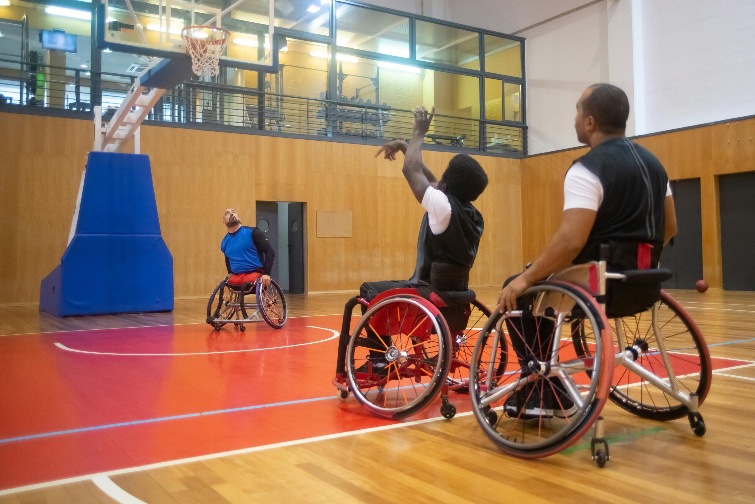 Wheelchair basketball players engaged in a competitive game indoors.
